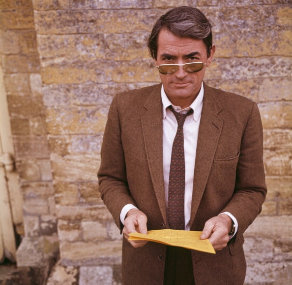 Vintage man in his 50s wearing blazer and aviator sunglasses.