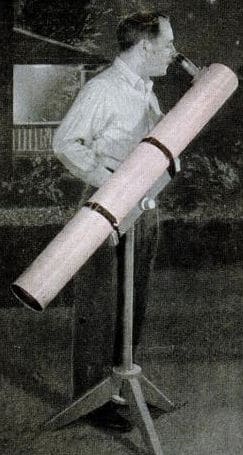 backyard telescope Vintage man looking through large backyard telescope.
