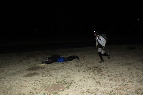 Two men are shooting the zombies.