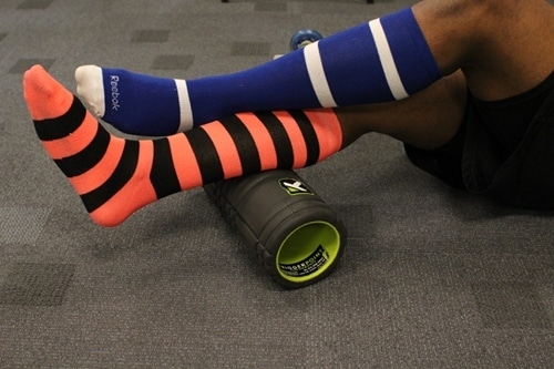 Using foam roller on calf muscles.