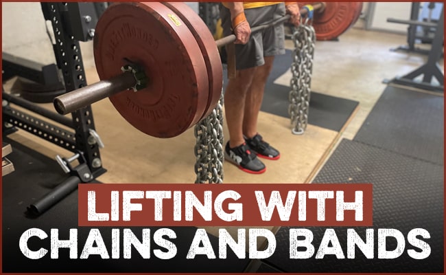 A person holds a barbell loaded with weight plates, heavy chains, and bands in a gym. Text at the bottom reads, "Lifting with Chains and Bands"—showcasing accommodating resistance training.