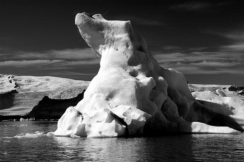 An iceberg in the water, showcasing its resiliency against natural forces.
