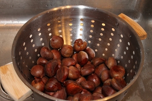 rinse chestnuts Rinsing chestnuts for roasting.