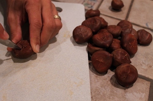 scoring chestnuts Cutting the edges of the chestnuts.