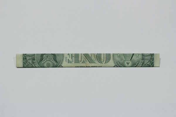 Double folded one dollar bill. 