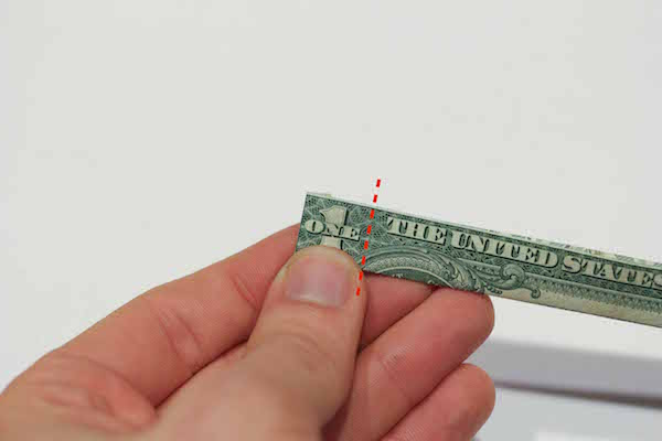 Folded left edge of one dollar bill. 