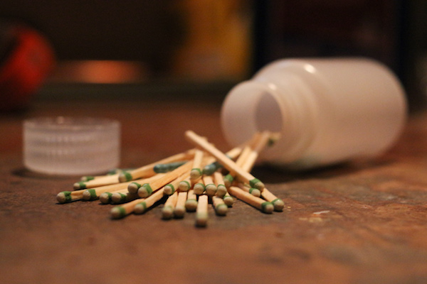 A jar of waterproof matches on a table.