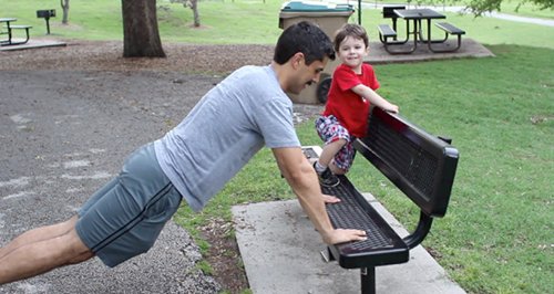 Vintage man doing Push incline exercise on the bench.