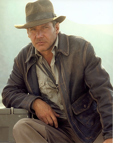 Harrison Fond wearing a leather jacket and cowboy hat.