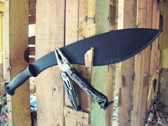 Fire starting tools hanging on wooden base. 