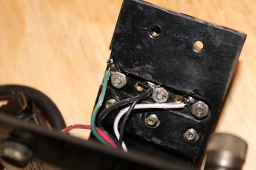 Vintage connecting new wires to terminals on top plate.