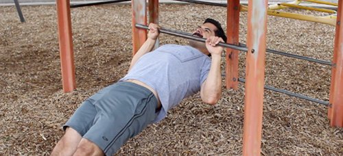 Vintage men doing inverted row exercise.
