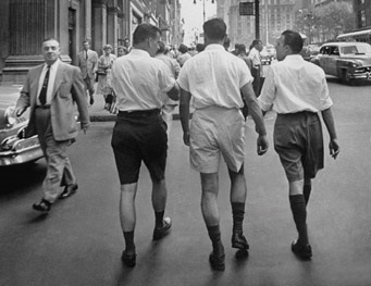 men walking down street wearing shorts - vintage