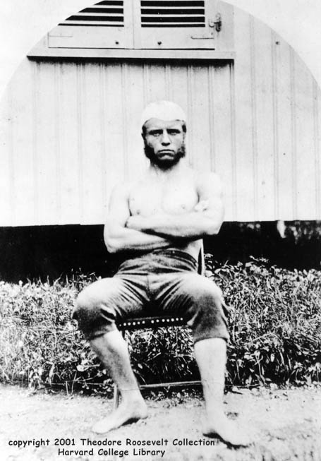 Theodore Roosevelt as a young man Teddy Roosevelt sitting on chair in college portrait.