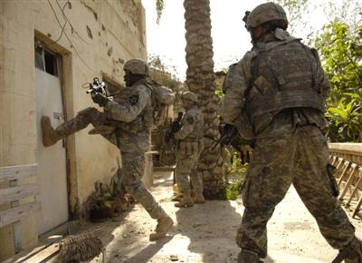 U.S. soldiers demonstrate how to break down a door in Iraq.