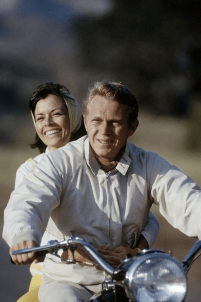 Steve mcqueen wearing harrington blouson jacket on motorcycle.